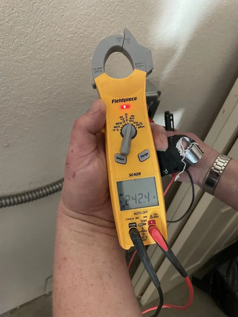 Voltage testing with clamp meter during Outlet Installation in North Aurora